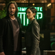 Neo and Trinity standing outside a coffee shop.